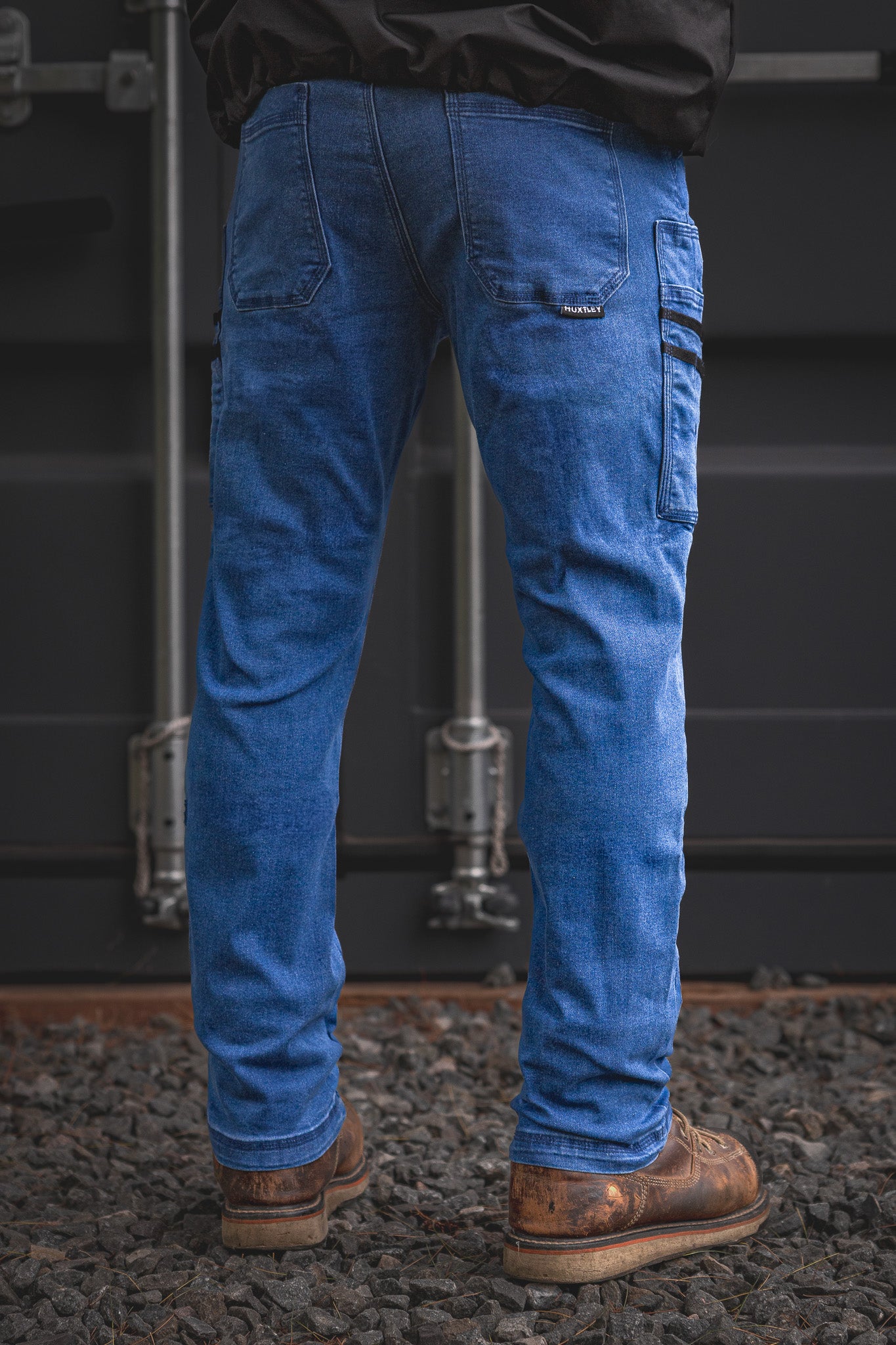 Rear angle of the RX-1 Relaxed Work Jeans in Stonewashed Blue, showcasing the dual thigh pockets and classic fit designed for durability and flexibility on-site.