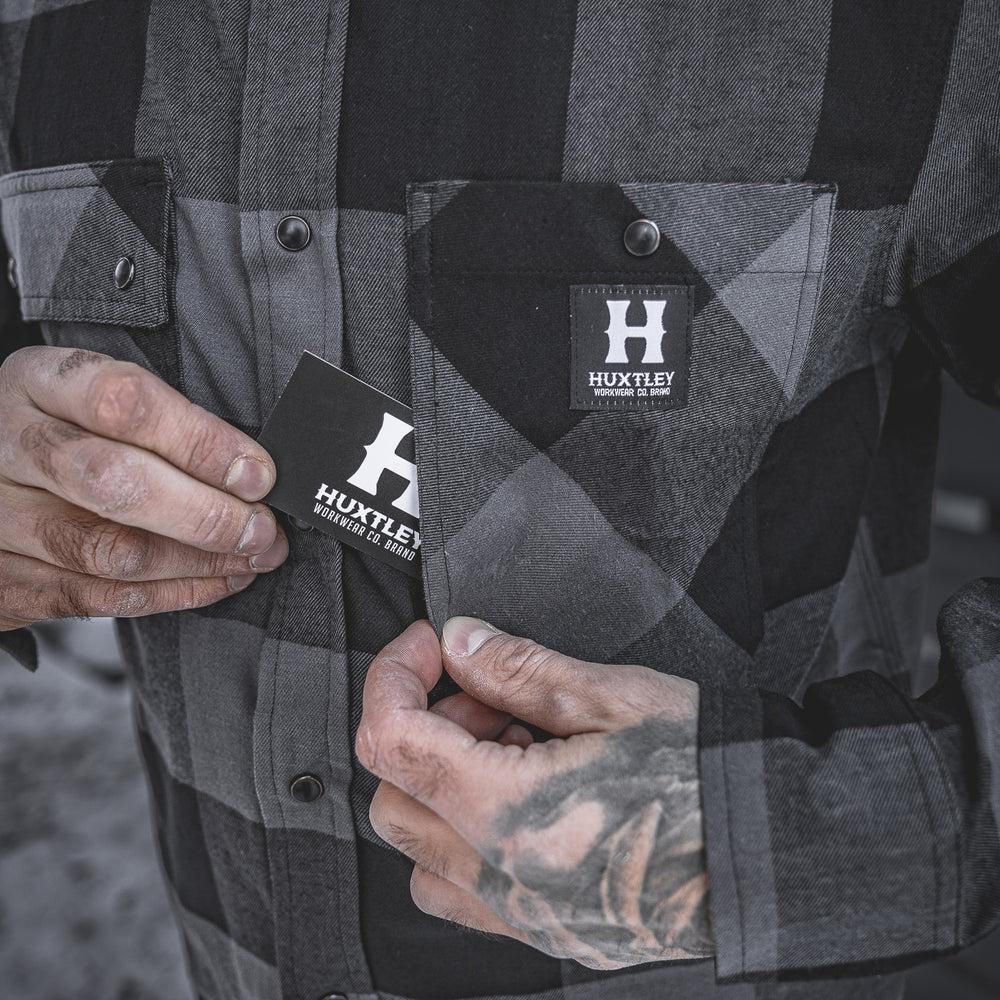 
                  
                    The Huxtley HD-57 Flex Flannel in Charcoal/Black features a discreet inner pocket tucked behind the chest flap—perfect for keeping small essentials secure while you’re on the move.
                  
                