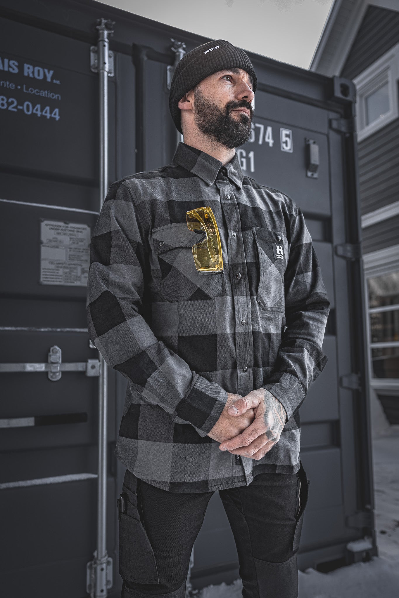 
                  
                    The Huxtley HD-57 Flex Flannel in Charcoal/Black shown in a real-world jobsite setting. With its rugged fit, stretch flannel build, and functional pocketing, it’s made to handle the cold and keep you moving.
                  
                