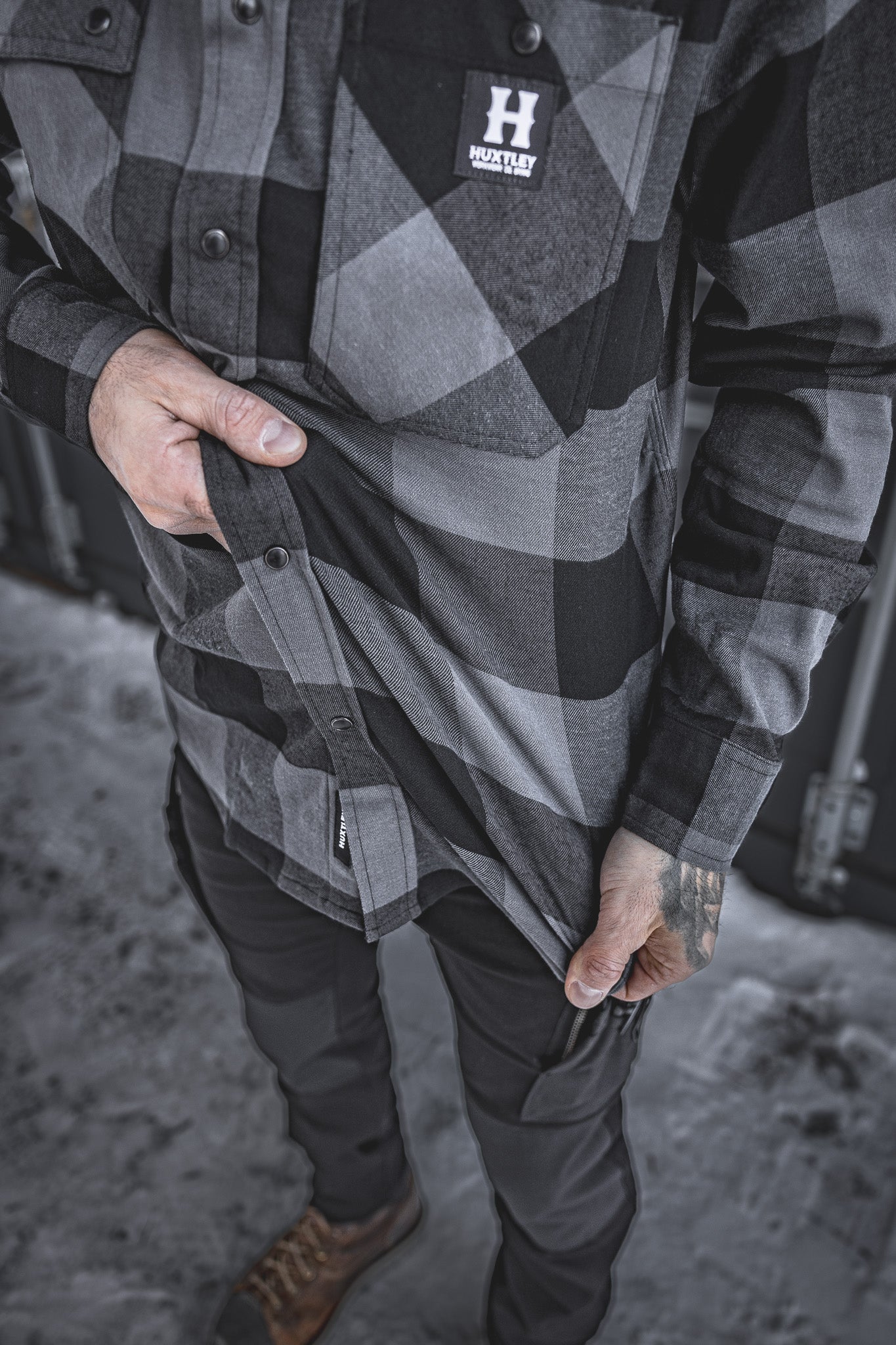 Close-up of the Huxtley HD-57 Flex Flannel in Charcoal/Black, showing off its built-in stretch for easy movement and jobsite mobility. This flannel works as hard as you do—no compromises on comfort or toughness.