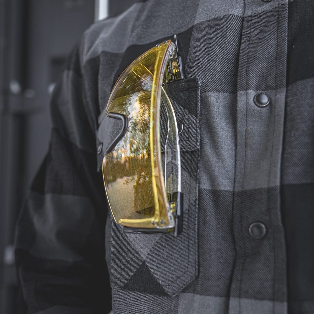 
                  
                    Detail of the Huxtley HD-57 Flex Flannel in Charcoal/Black, featuring a chest pocket perfectly sized for safety glasses or small gear. Designed for tradesmen who need function and durability on the go.
                  
                