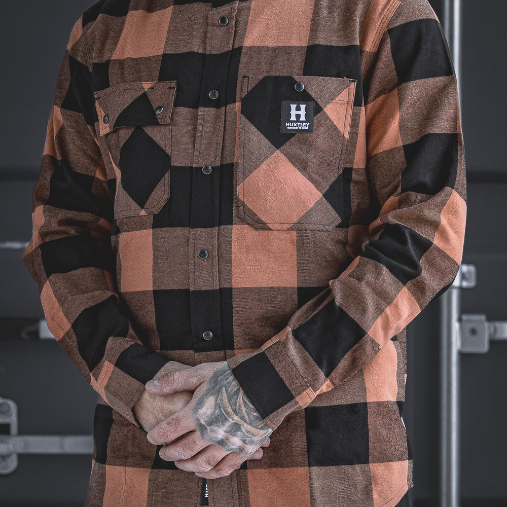 The Huxtley HD-57 Flex Flannel in Whiskey/Black delivers heavyweight comfort and jobsite toughness. Designed with flex fabric and rugged details, this buffalo plaid shirt blends classic style with work-ready performance.