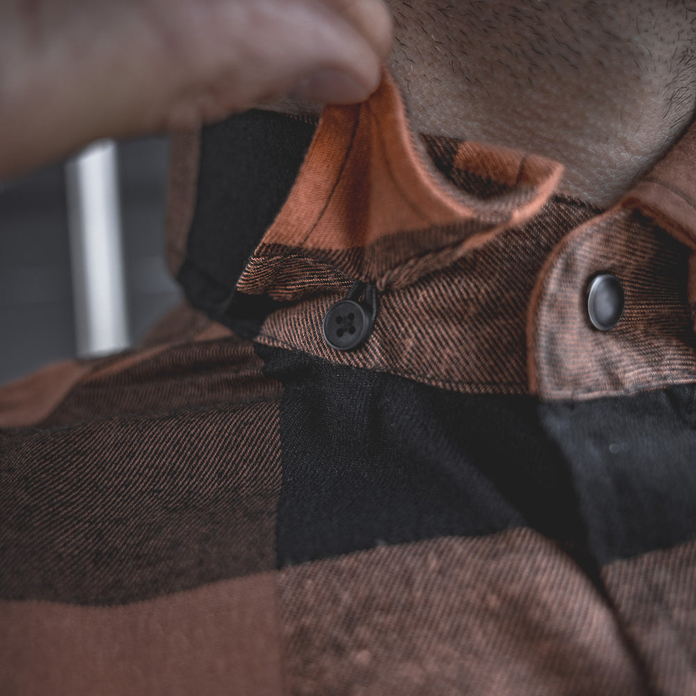 
                  
                    Detail shot of the Huxtley HD-57 Flex Flannel in Whiskey/Black, featuring a hidden collar button to keep your look sharp and your collar in place all day long—whether you're working hard or kicking back.
                  
                
