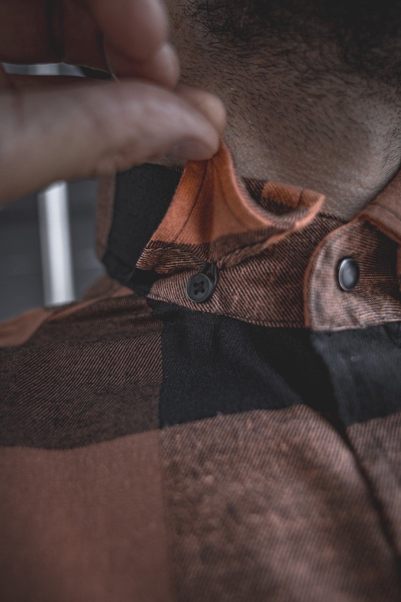 
                  
                    Detail shot of the Huxtley HD-57 Flex Flannel in Whiskey/Black, featuring a hidden collar button to keep your look sharp and your collar in place all day long—whether you're working hard or kicking back.
                  
                