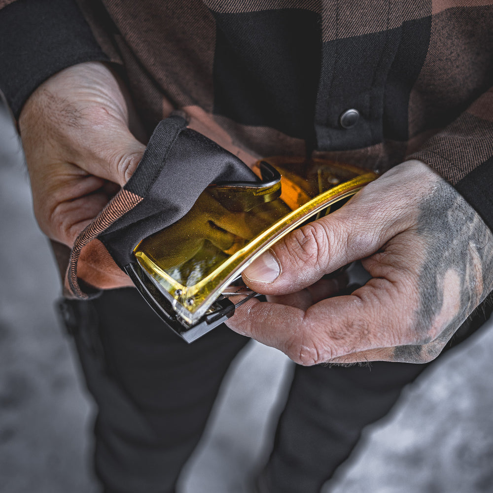 
                  
                    The Huxtley HD-57 Flex Flannel in Whiskey/Black comes equipped with a built-in lens cloth for quick cleaning of safety glasses or goggles. Smart details like this make it a must-have on the jobsite.
                  
                