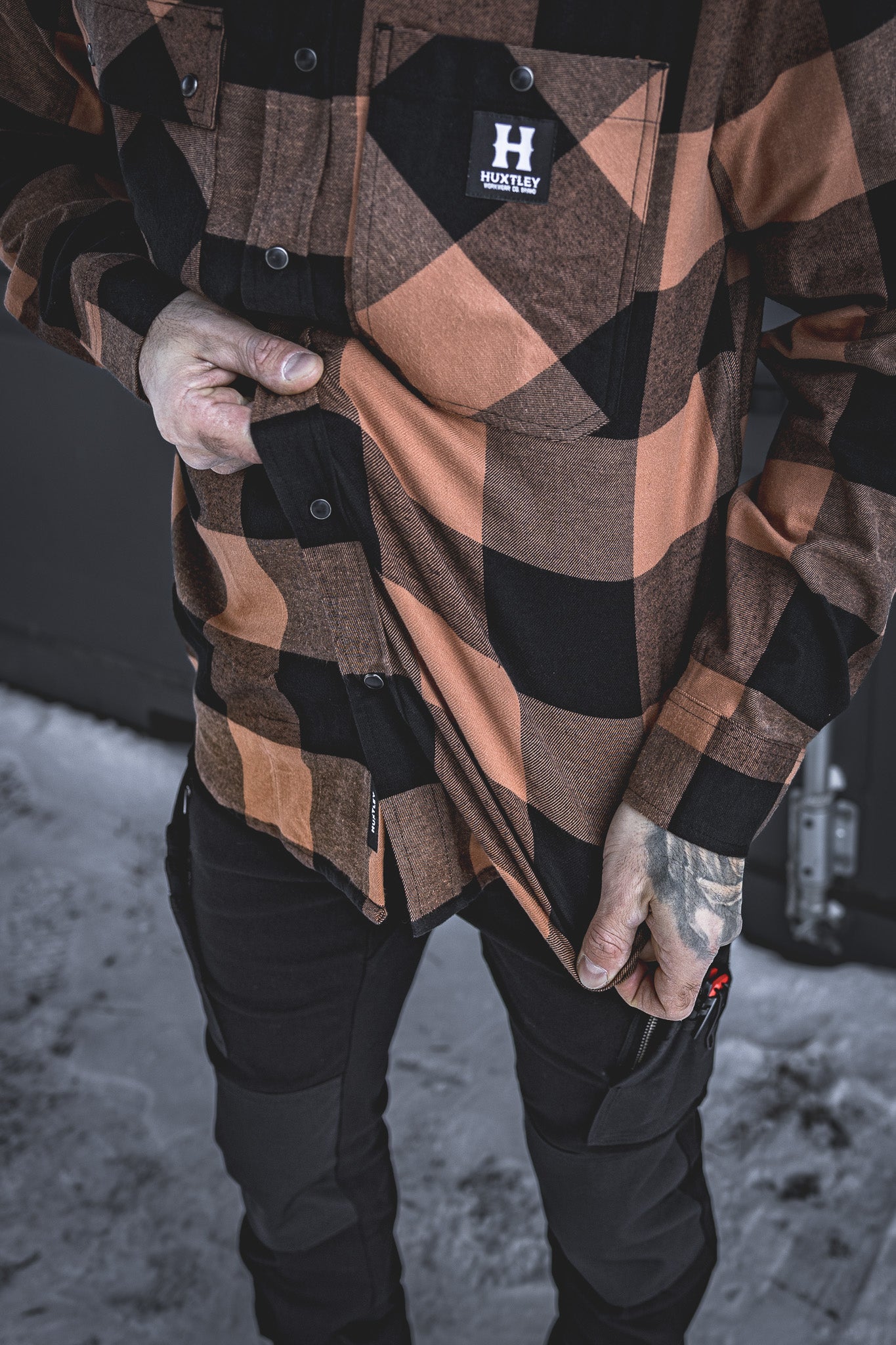 Close-up of the Huxtley HD-57 Flex Flannel in Whiskey/Black, highlighting its built-in stretch for maximum comfort and mobility. Perfect for tough jobs and long days, this flannel flexes when you do without sacrificing durability.