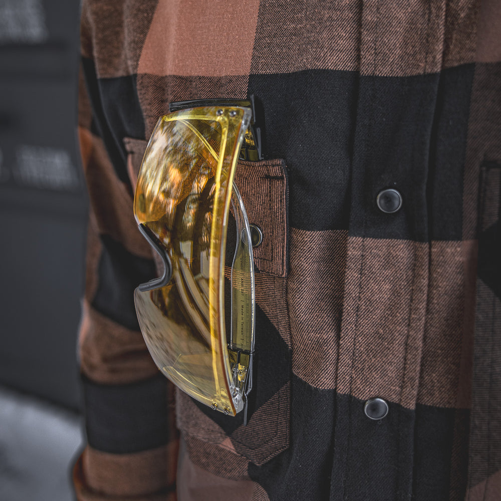 
                  
                    Close-up of the Huxtley HD-57 Flex Flannel in Whiskey/Black featuring a secure chest pocket, perfect for holding safety glasses or small tools. Built for jobsite function with everyday style in mind.
                  
                