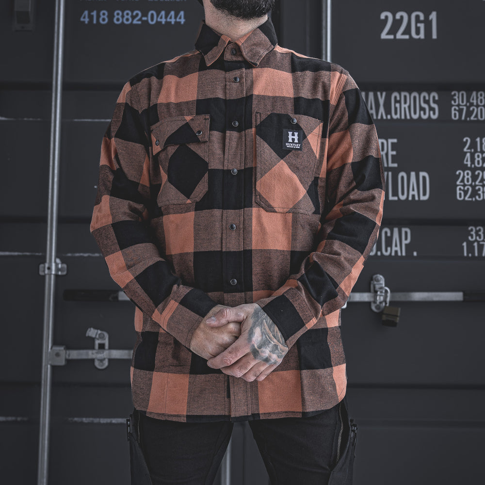 
                  
                    The Huxtley HD-57 Flex Flannel in Whiskey/Black pairs rugged plaid style with jobsite functionality. Featuring a modern fit, stretch fabric, and reinforced utility details—ready for work, and everything in between.
                  
                