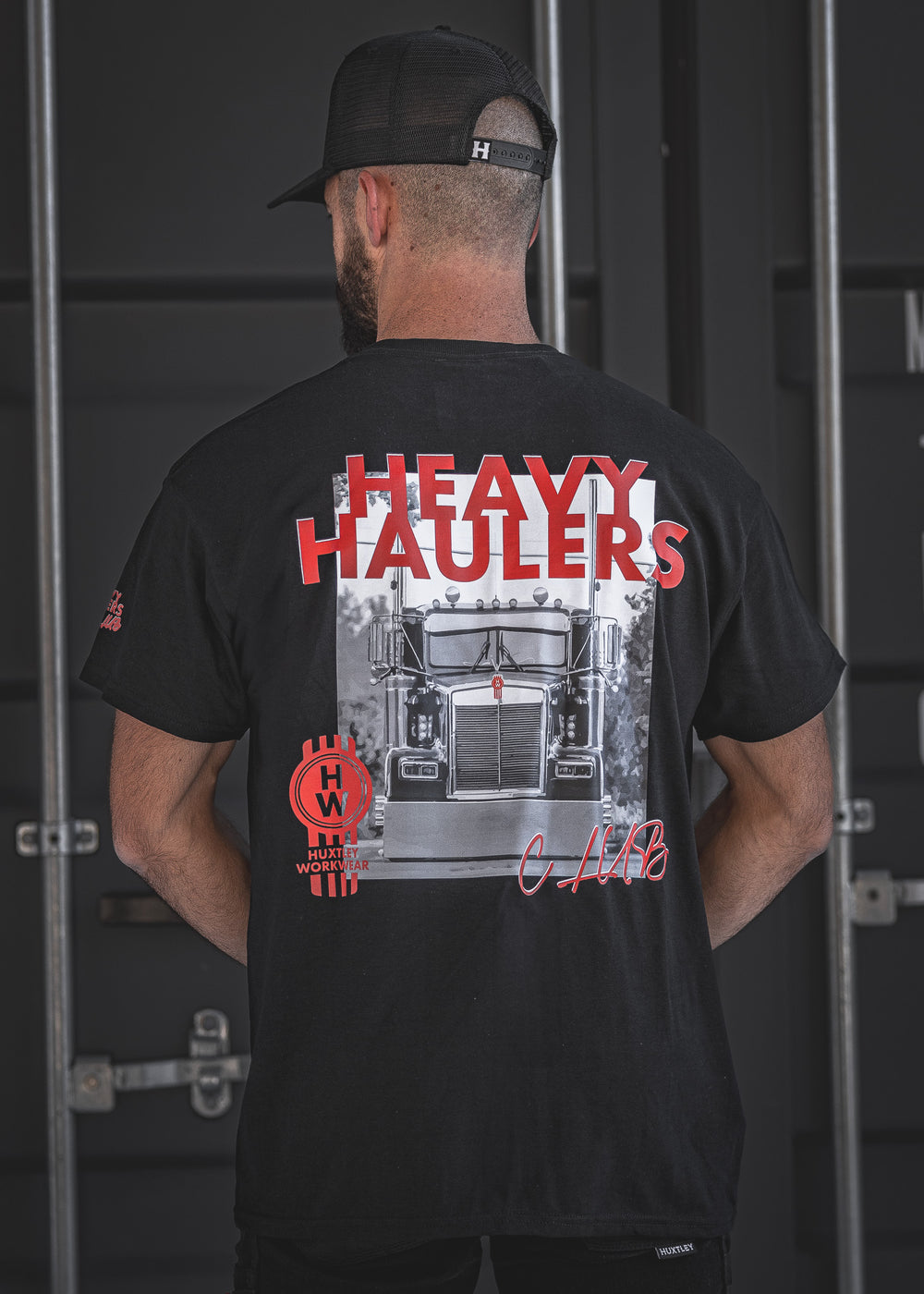 Join the Heavy Haulers Club with this Huxtley Workwear t-shirt featuring a bold Kenworth truck print and signature red accents. Built for the big rig lifestyle, this tee brings diesel attitude and all-day comfort.