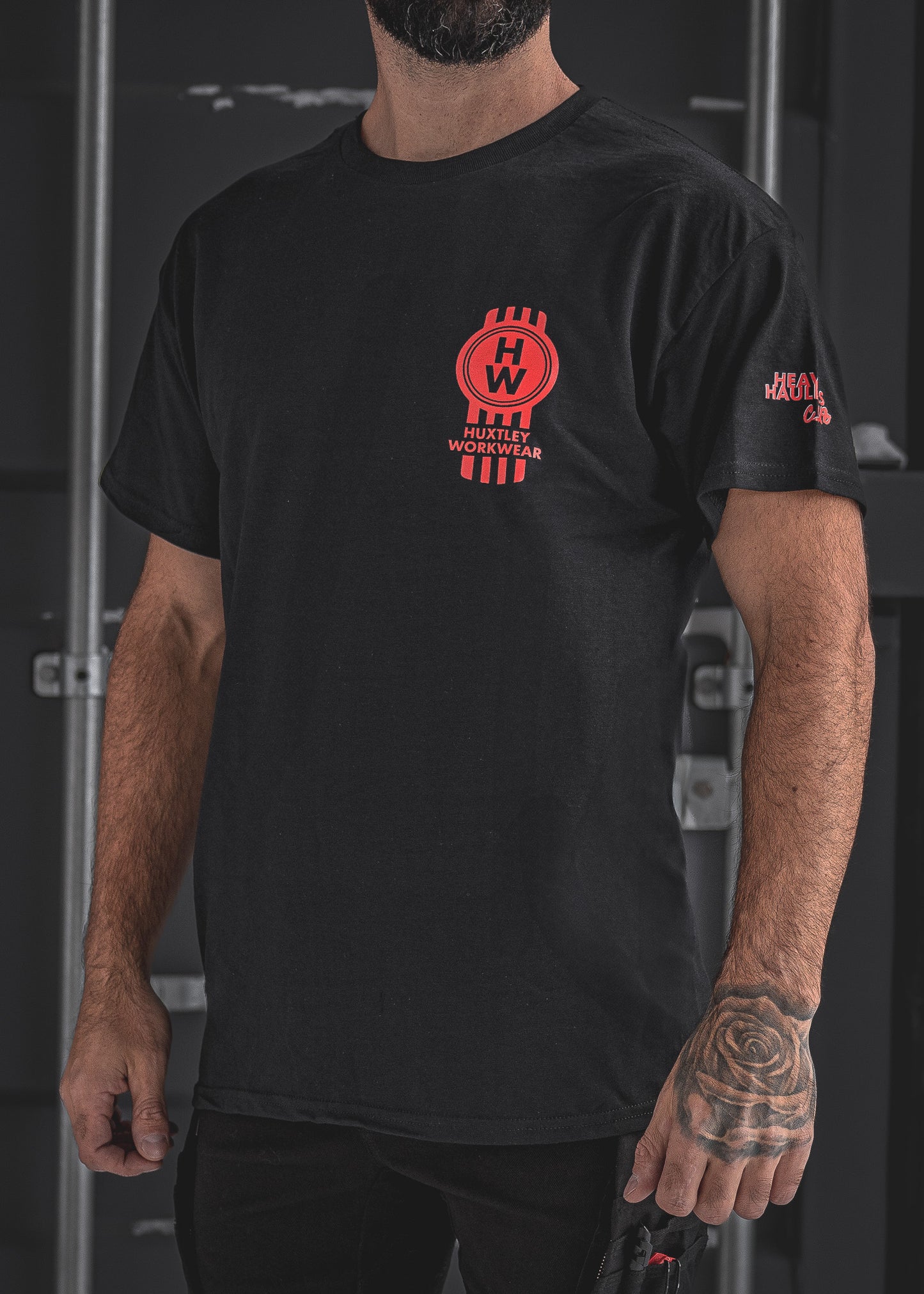 
                  
                    Rep the road in the Huxtley Heavy Haulers Club tee. This black trucker shirt features bold red graphics, a front HW logo hit, and a full-size rig on the back. Made for the diesel crew, built to haul hard
                  
                