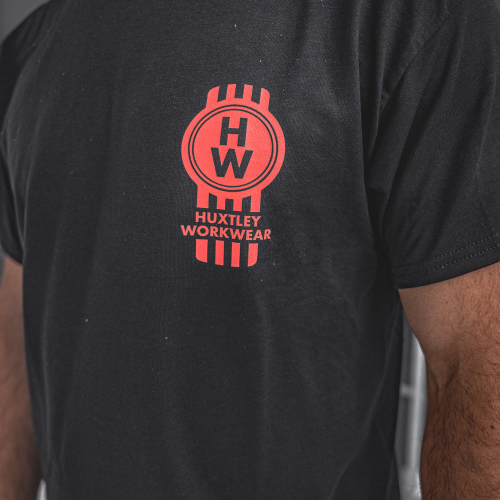 
                  
                    Close-up of the Heavy Haulers Club tee by Huxtley Workwear. Features a bold red HW crest on the chest—built for the ones who haul hard, grind daily, and wear it proud.
                  
                