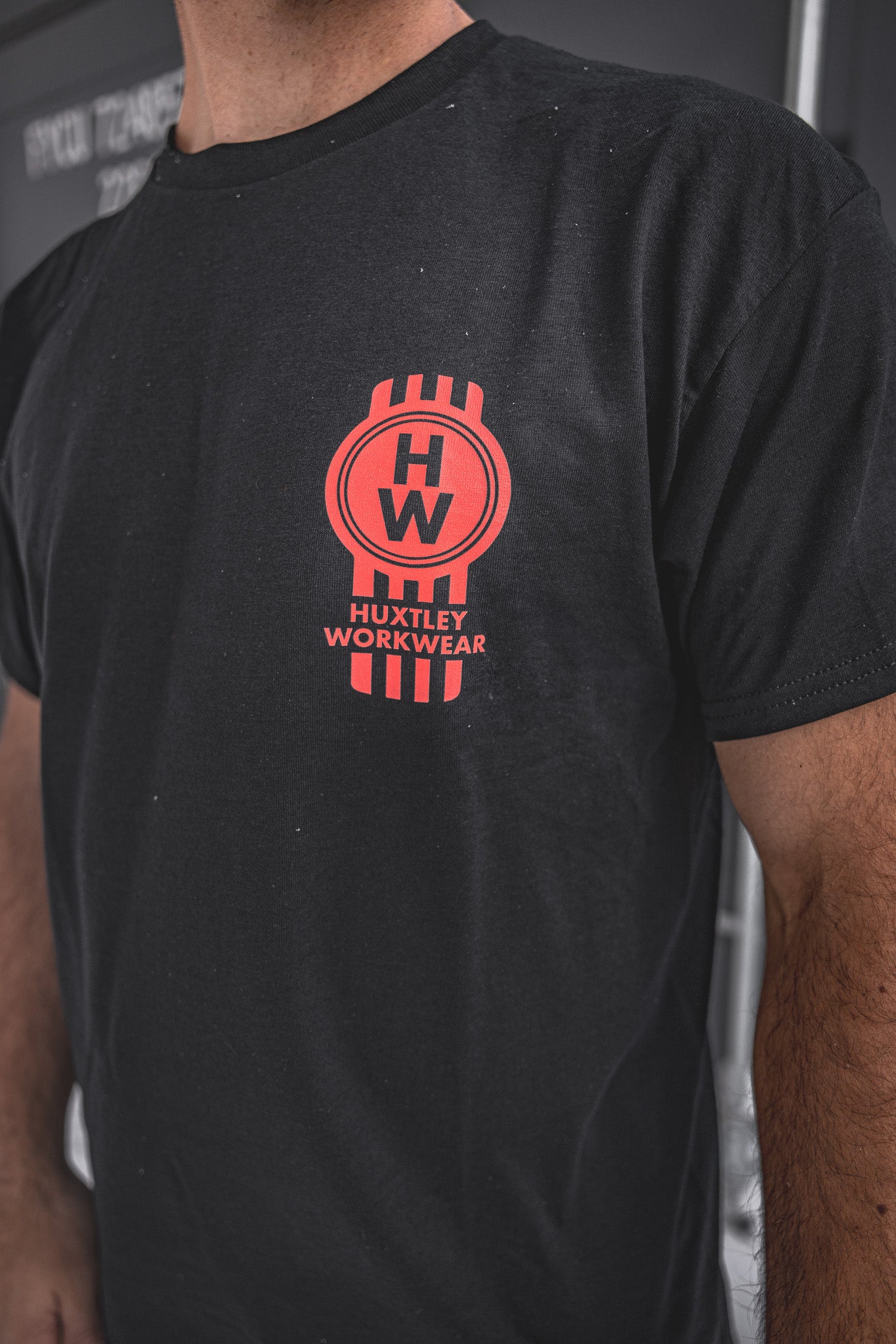 
                  
                    Close-up of the Heavy Haulers Club tee by Huxtley Workwear. Features a bold red HW crest on the chest—built for the ones who haul hard, grind daily, and wear it proud.
                  
                
