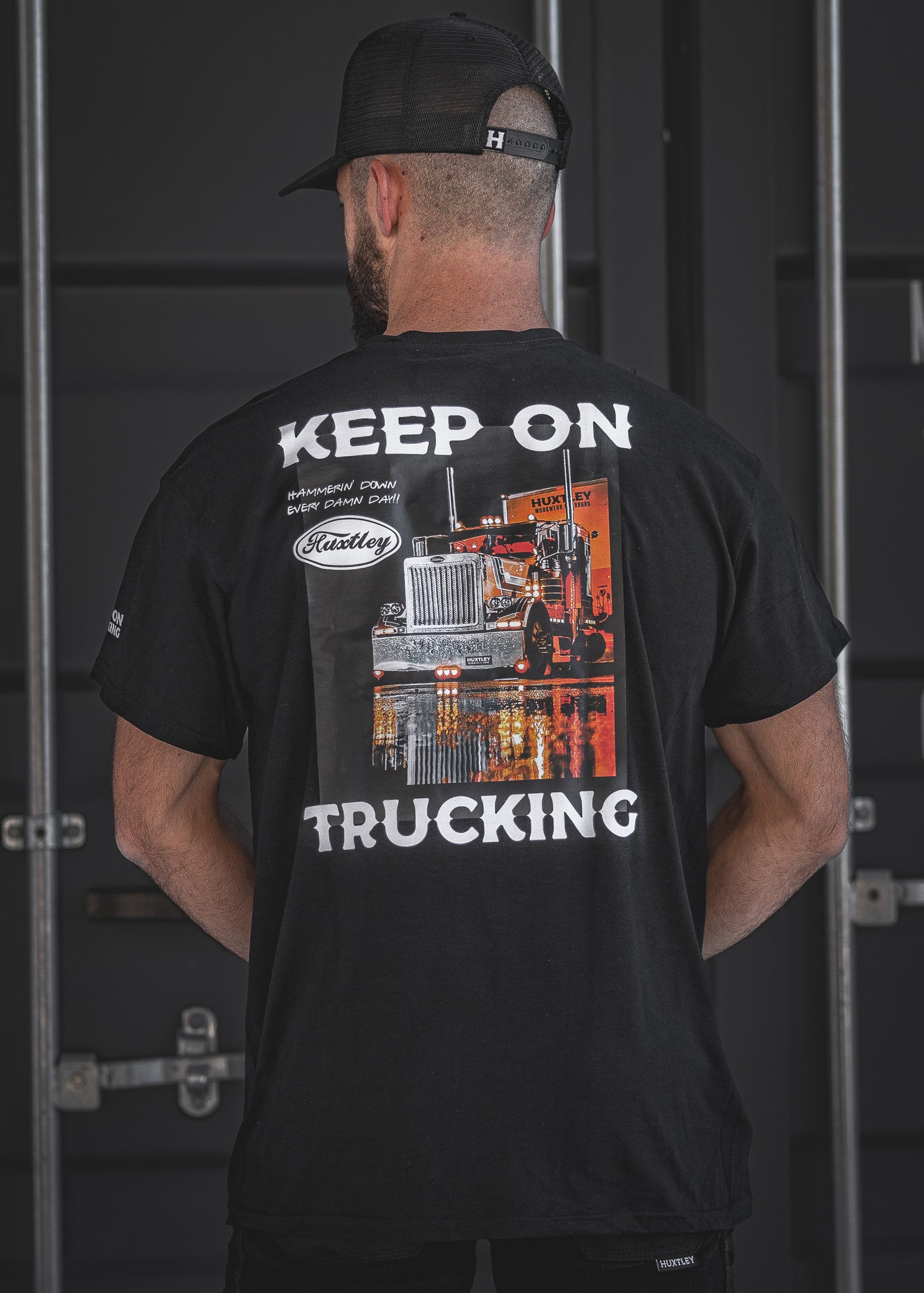 The Huxtley “Keep On Trucking” tee in black features a bold big rig graphic with the motto “Hammerin’ Down Every Damn Day!” Made for hard-working haulers and highway legends who never lift off the throttle.