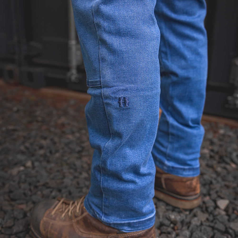 
                  
                    Close-up view of the RX-1 Relaxed Work Jeans in Stonewashed Blue, showing the stitched knee patch and signature 'H' logo built for durability on the job.
                  
                
