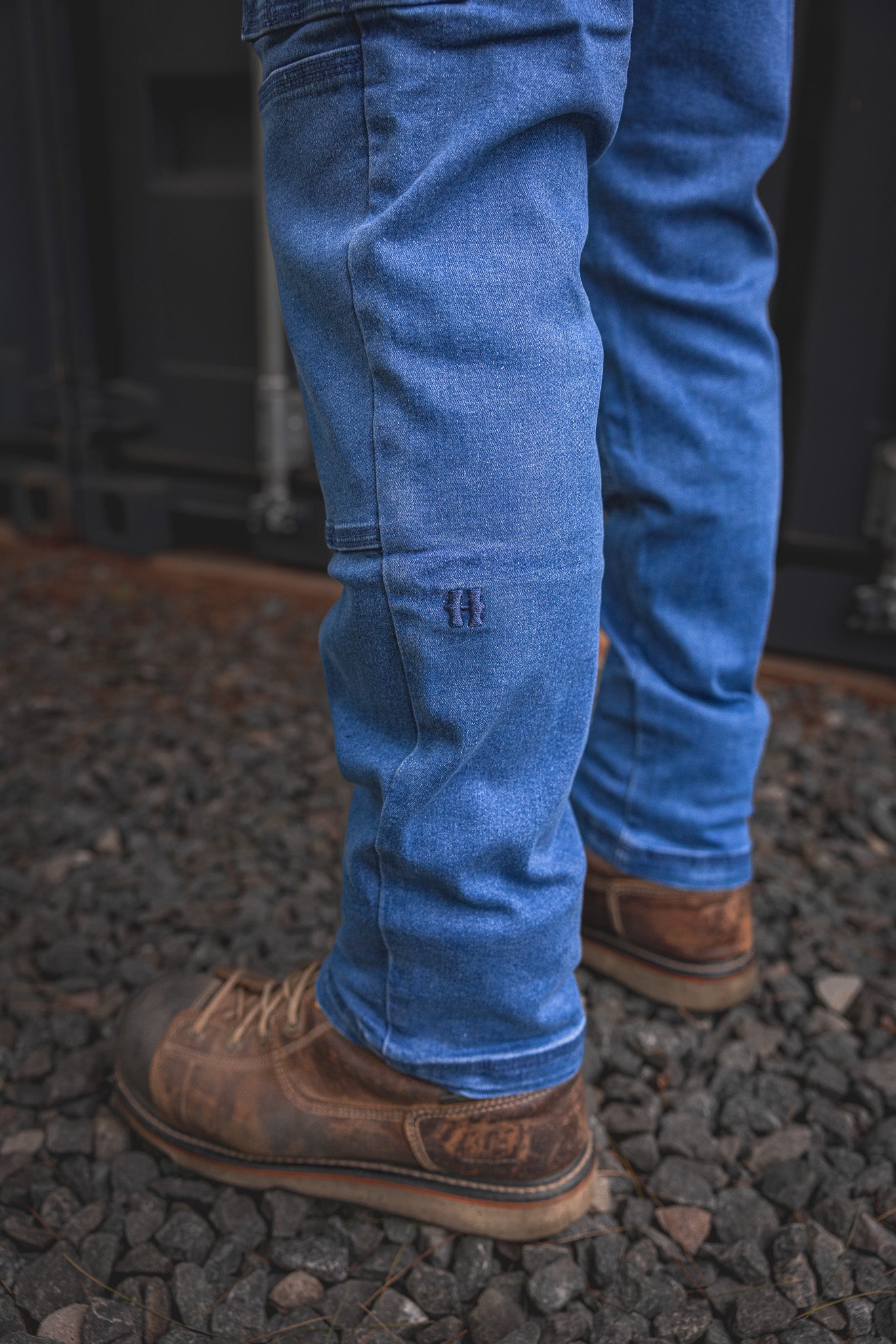 
                  
                    Close-up view of the RX-1 Relaxed Work Jeans in Stonewashed Blue, showing the stitched knee patch and signature 'H' logo built for durability on the job.
                  
                