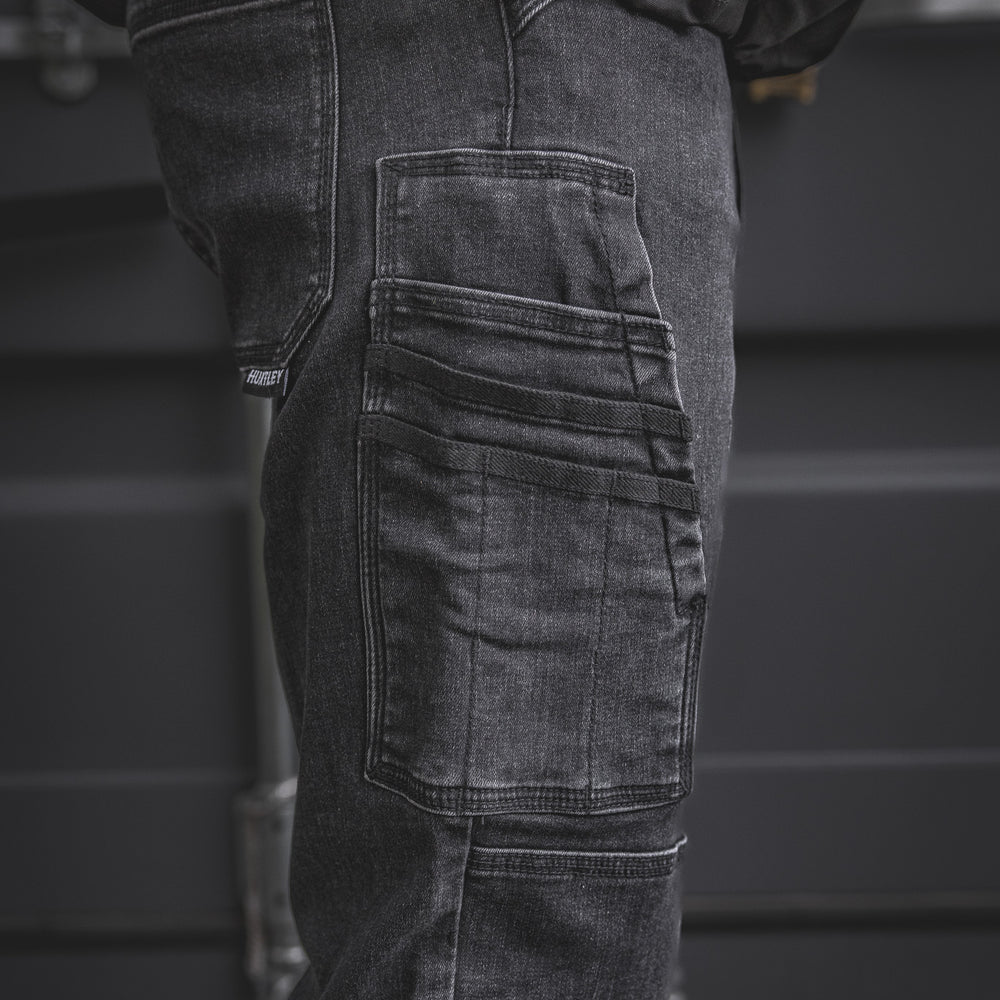
                  
                    Detailed view of the RX-1 Relaxed Work Jeans in Stonewashed Black, highlighting the multi-tool side pocket built for phones, small tools, or meters.
                  
                