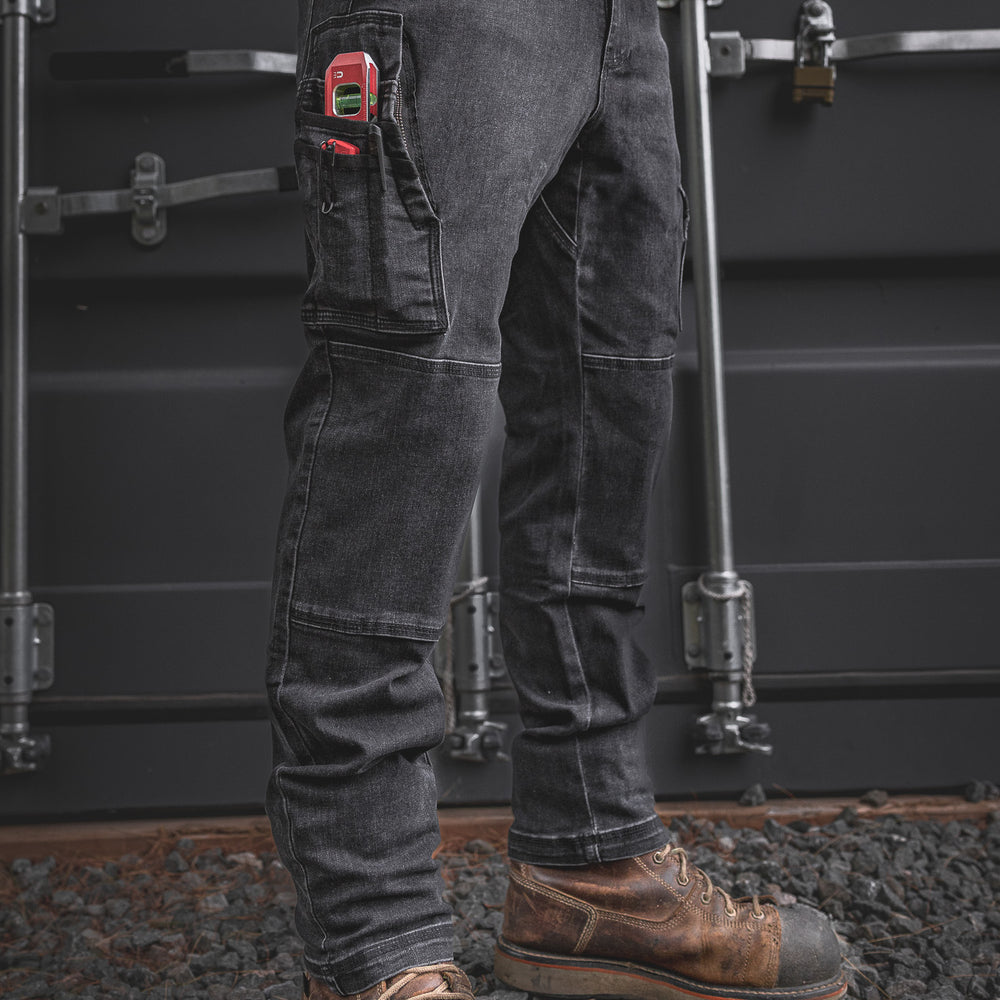 
                  
                    Front angle view of the RX-1 Relaxed Work Jeans in Stonewashed Black, packed with essential jobsite tools. Durable, stretch-built denim with reinforced pockets made for tough tasks and long days.
                  
                