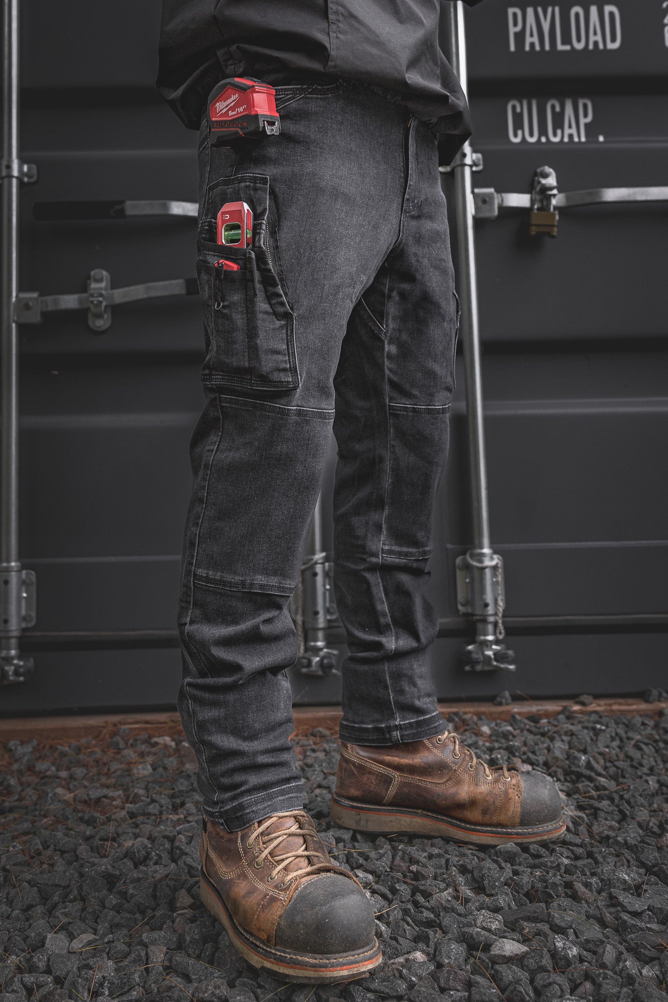 
                  
                    Front angle view of the RX-1 Relaxed Work Jeans in Stonewashed Black, packed with essential jobsite tools. Durable, stretch-built denim with reinforced pockets made for tough tasks and long days.
                  
                
