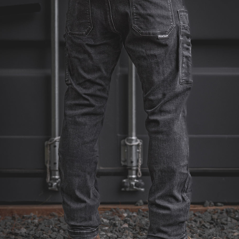 Back view of the RX-1 Relaxed Work Jeans in Stonewashed Black showing dual rear pockets and a reinforced utility pocket, combining function and laid-back comfort for jobsite durability.