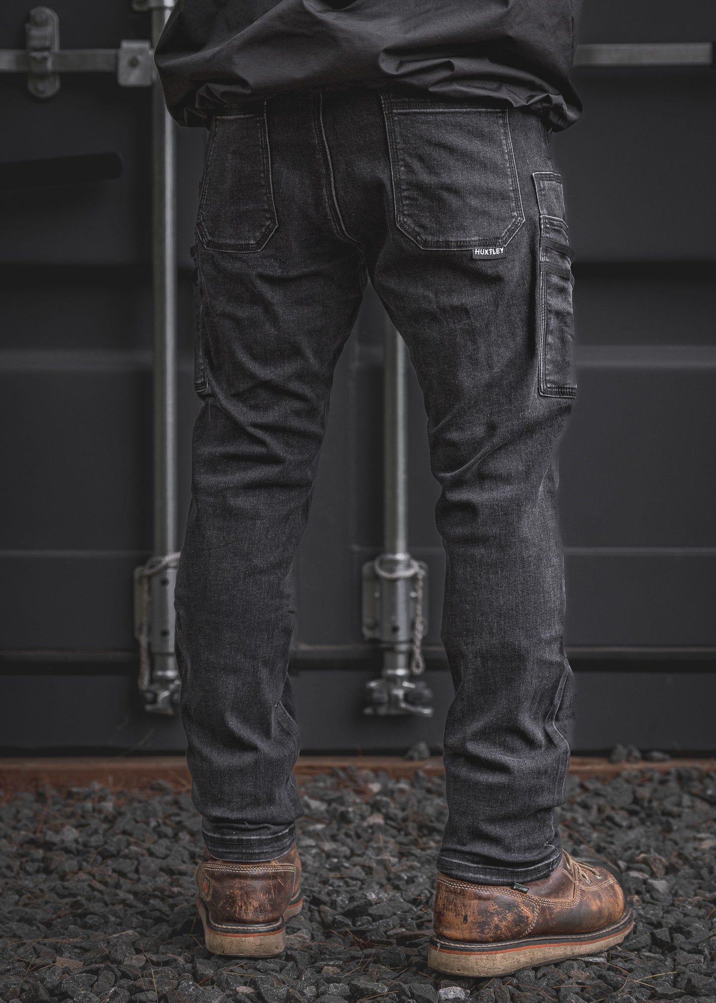 Back view of the RX-1 Relaxed Work Jeans in Stonewashed Black showing dual rear pockets and a reinforced utility pocket, combining function and laid-back comfort for jobsite durability.