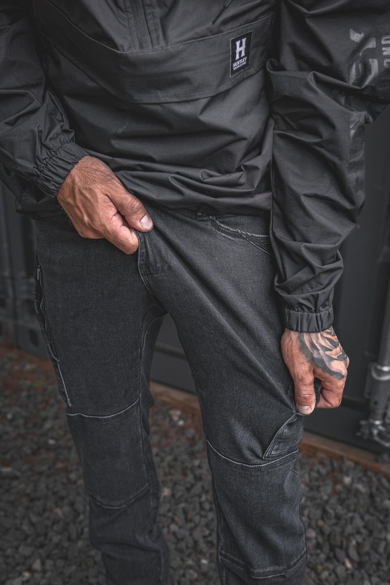 
                  
                    Close-up of the RX-1 Relaxed Work Jeans in Stonewashed Black showing the built-in stretch fabric. Designed for trades who bend, squat, and move all day.
                  
                