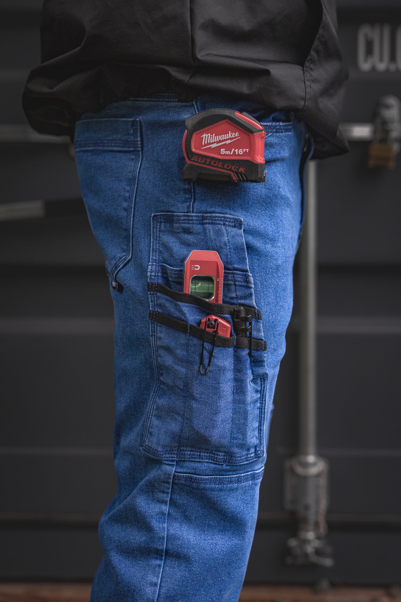 
                  
                    RX-1 Relaxed Work Jeans in Stonewashed Blue loaded with gear—featuring reinforced side pockets and tool loops that handle tape measures, levels, and more without flinching.
                  
                