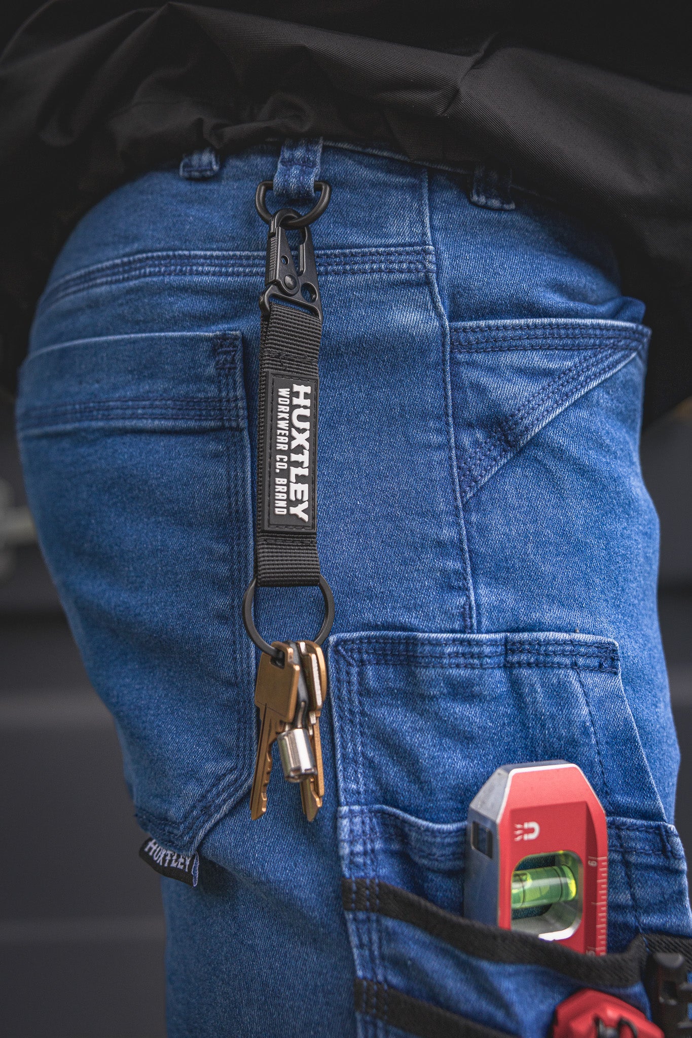 
                  
                    RX-1 Relaxed Work Jeans in Stonewashed Blue shown with lanyard hook in action—perfect for keeping keys, badges, or tags secure on-site while staying hands-free.
                  
                