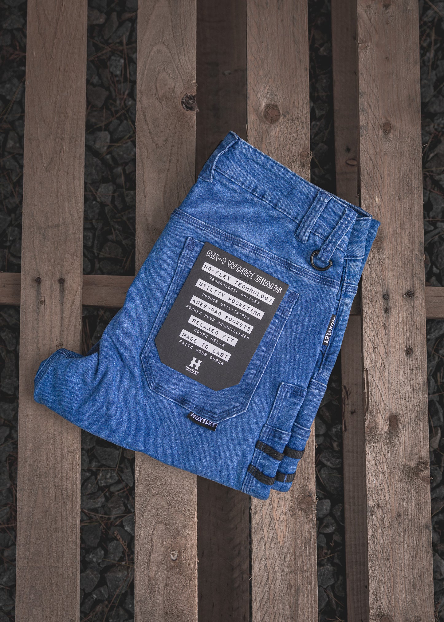 
                  
                    RX-1 Relaxed Work Jeans in Stonewashed Blue, neatly folded to reveal the back pocket and feature tag—showcasing HD-Flex stretch, knee pad pockets, utility loops, and all-day comfort construction.
                  
                