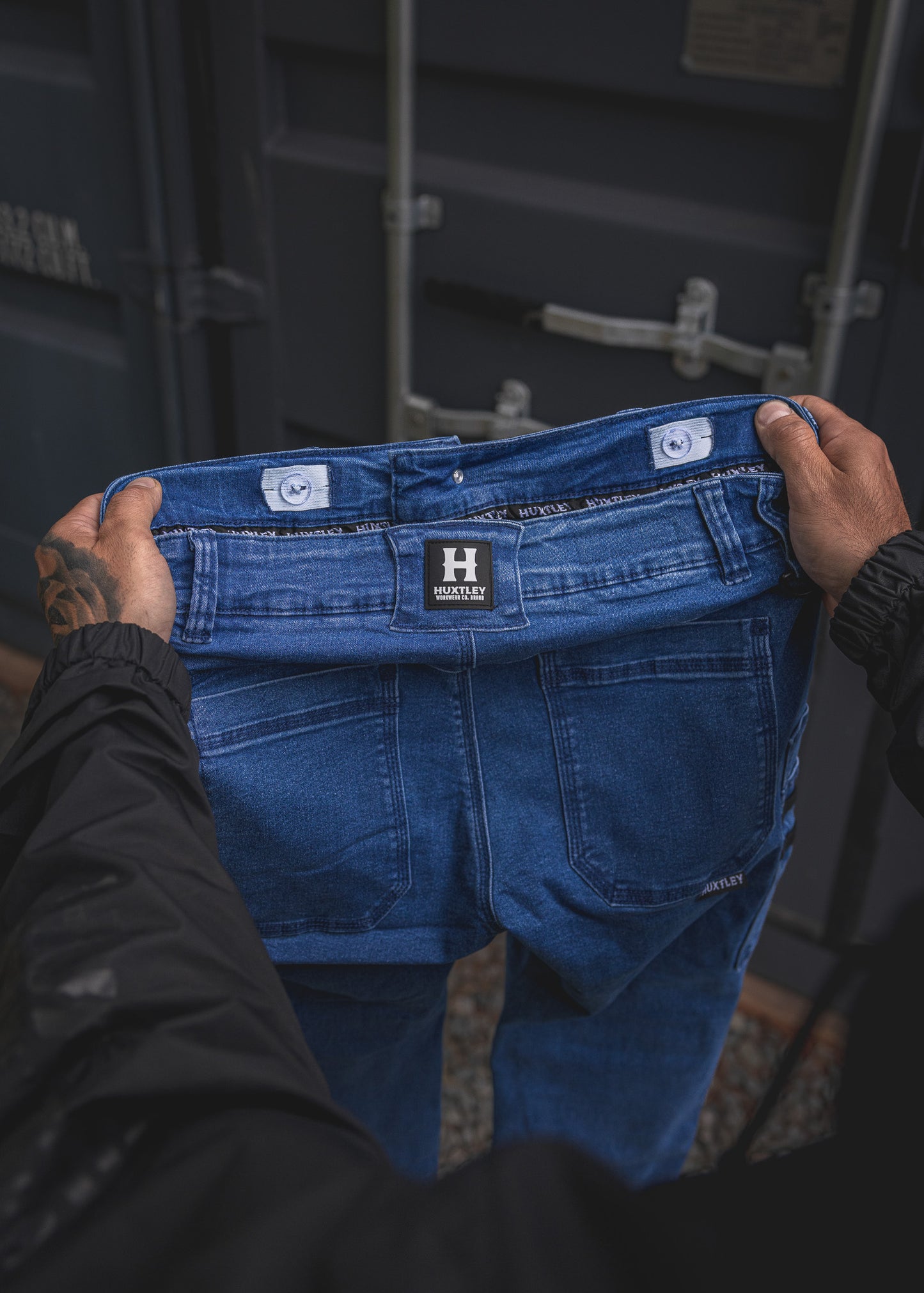 
                  
                    Close-up of the RX-1 Relaxed Work Jeans in Stonewashed Blue, highlighting the inside waistband and adjustable interior button tabs—engineered for all-day fit and durability on site.
                  
                