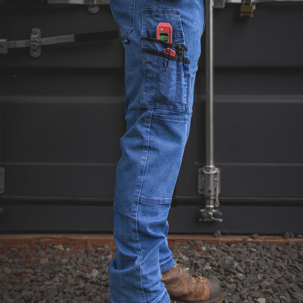 
                  
                    RX-1 Relaxed Work Jeans in Stonewashed Blue shown packed with gear—built with utility straps and secure pockets made to keep your tools locked in and close at hand.
                  
                