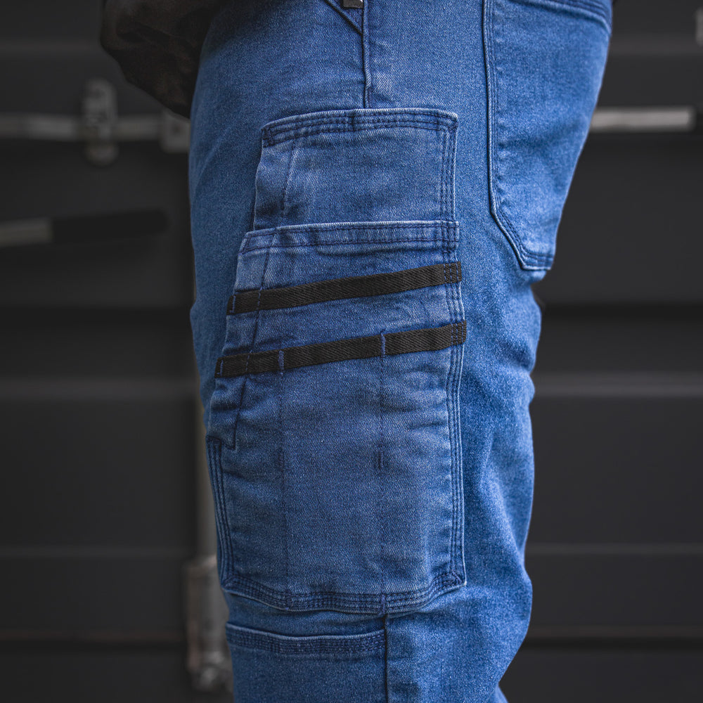 
                  
                    Zoomed view of the RX-1 Relaxed Work Jeans’ signature side pocket system in Stonewashed Blue, with black webbing accents made for tools, hardware, and everyday jobsite use.
                  
                