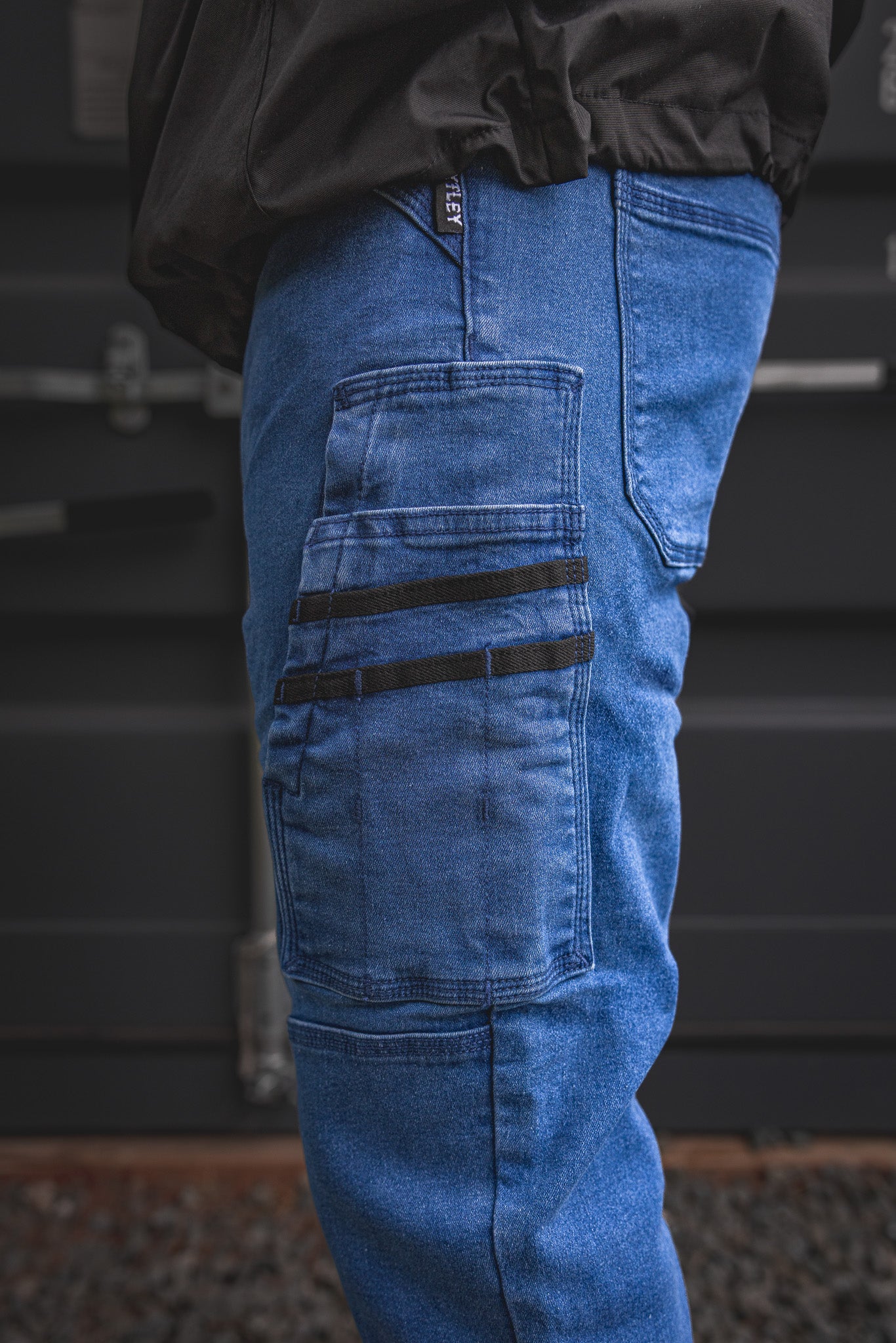 
                  
                    Zoomed view of the RX-1 Relaxed Work Jeans’ signature side pocket system in Stonewashed Blue, with black webbing accents made for tools, hardware, and everyday jobsite use.
                  
                