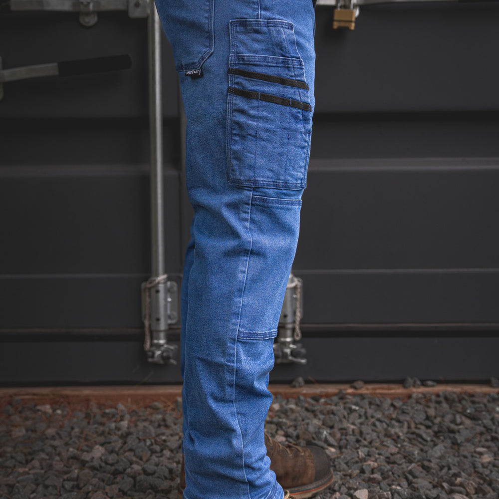 
                  
                    Side angle of the RX-1 Relaxed Work Jeans in Stonewashed Blue, highlighting the multi-function utility pocket layout and stretch fit—made for jobsite toughness and everyday comfort.
                  
                