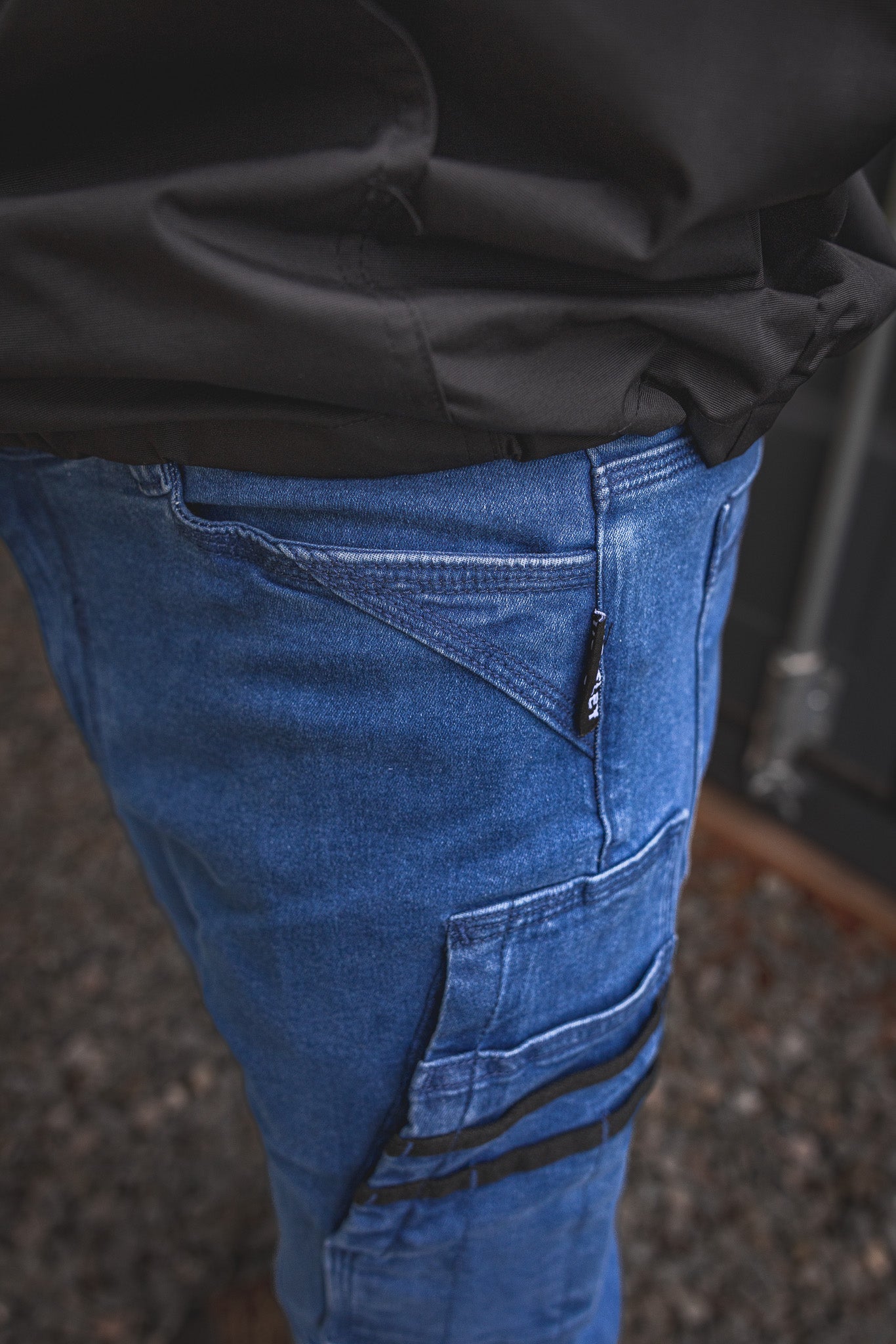
                  
                    RX-1 Relaxed Work Jeans in Stonewashed Blue shown in close-up, highlighting the reinforced angled pocket design and woven Huxtley tag—built for everyday grind and jobsite hustle.
                  
                