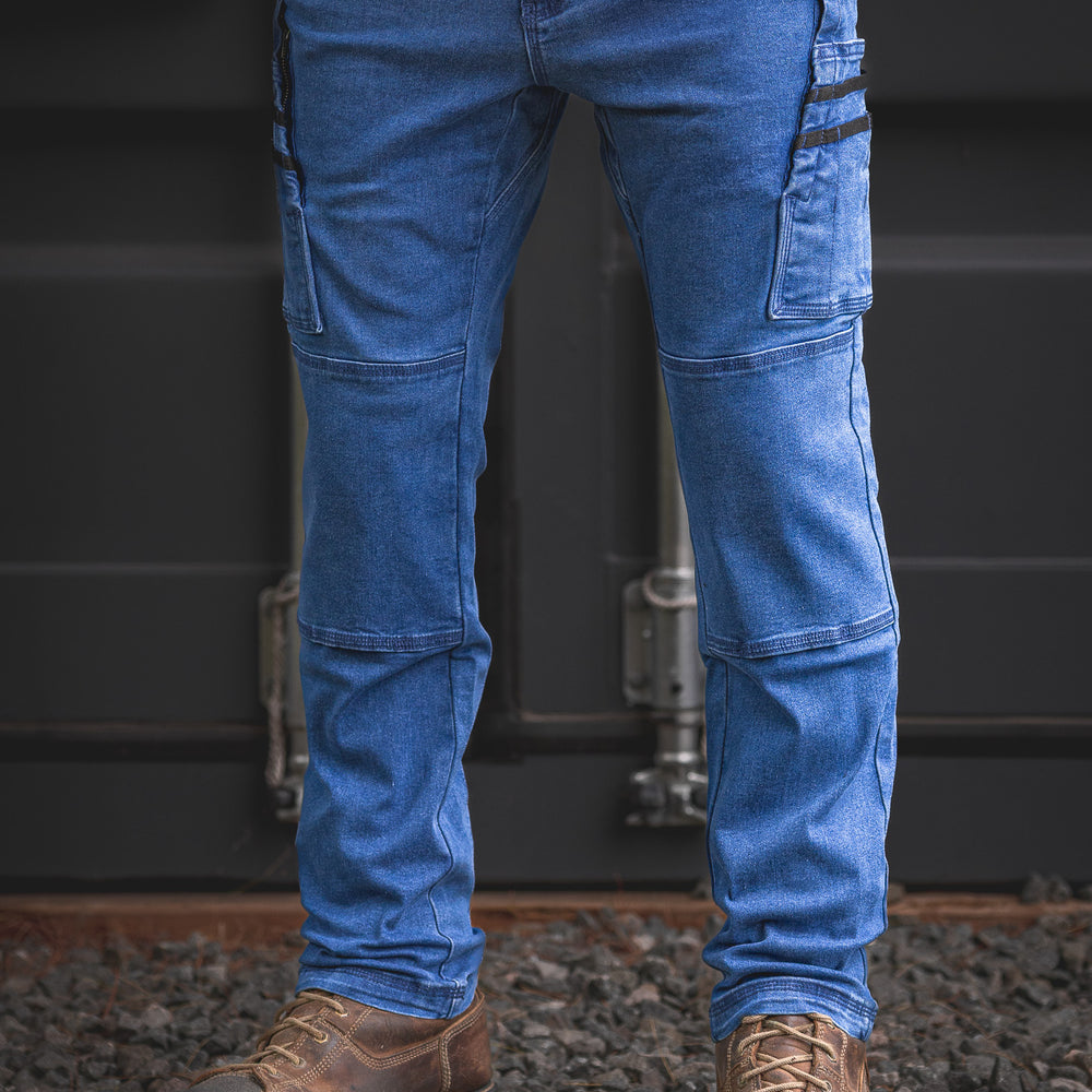 RX-1 Work Jeans in stonewashed blue. Durable stretch denim, relaxed fit, double-layered knees and cargo pockets. Tough enough for site life, sharp enough for the bar.