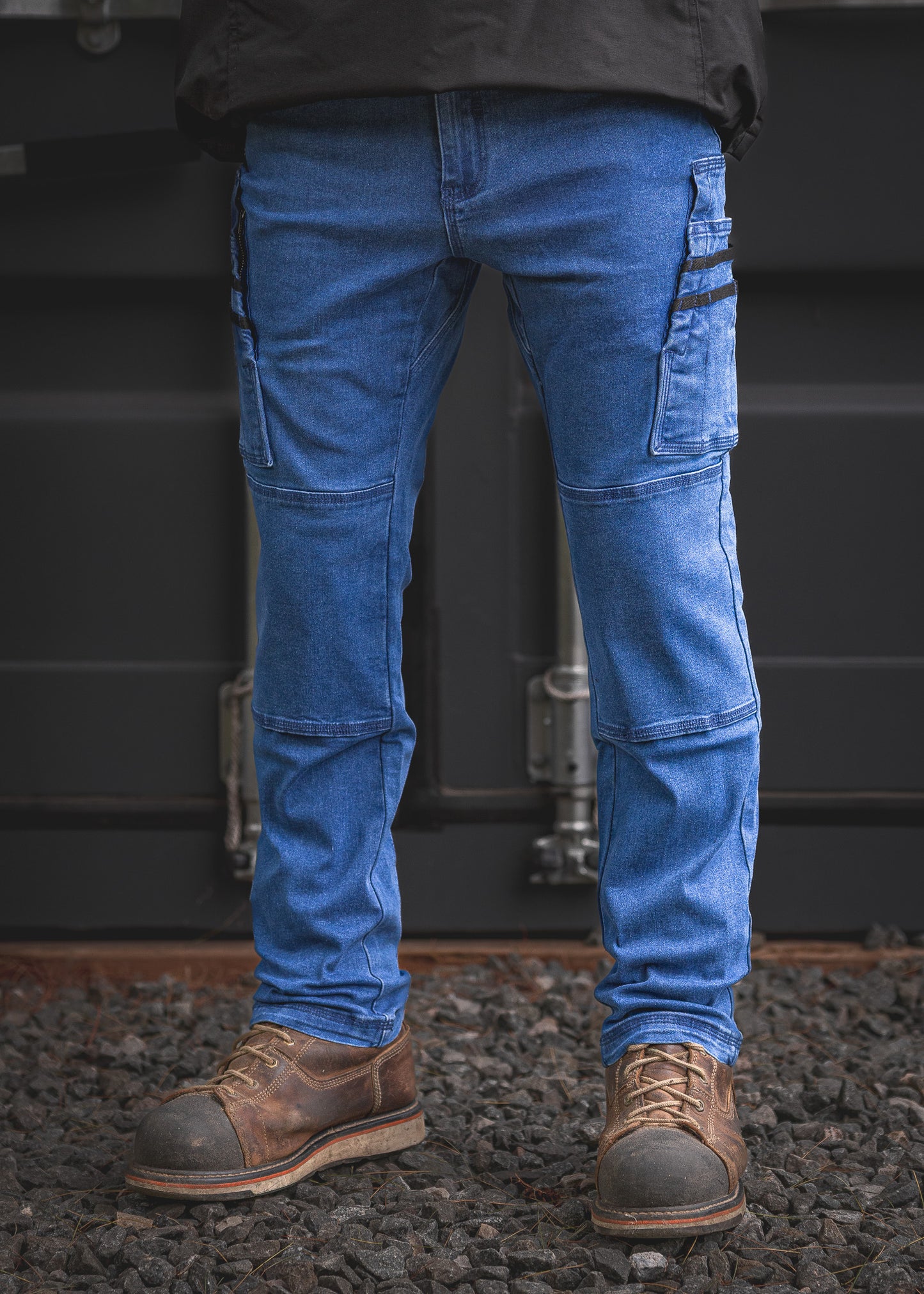 RX-1 Work Jeans in stonewashed blue. Durable stretch denim, relaxed fit, double-layered knees and cargo pockets. Tough enough for site life, sharp enough for the bar.