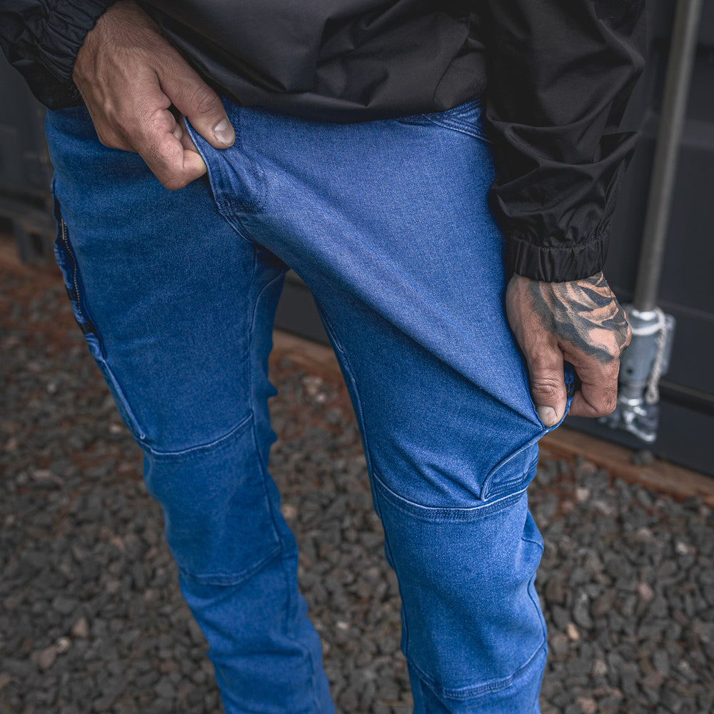 
                  
                    Model shows off the stretch of the RX-1 Relaxed Work Jeans in Stonewashed Blue — built for total freedom of movement on the jobsite.
                  
                