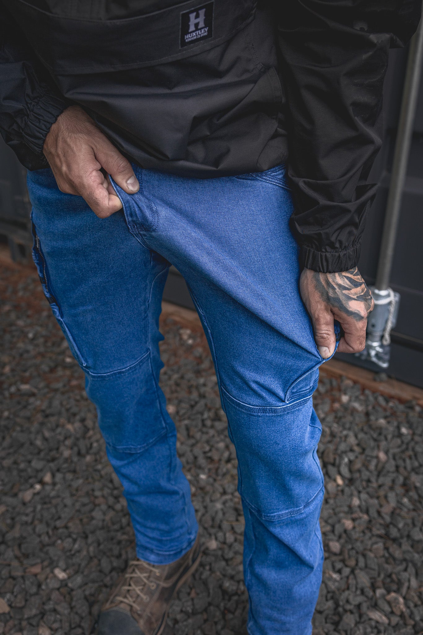 
                  
                    Model shows off the stretch of the RX-1 Relaxed Work Jeans in Stonewashed Blue — built for total freedom of movement on the jobsite.
                  
                